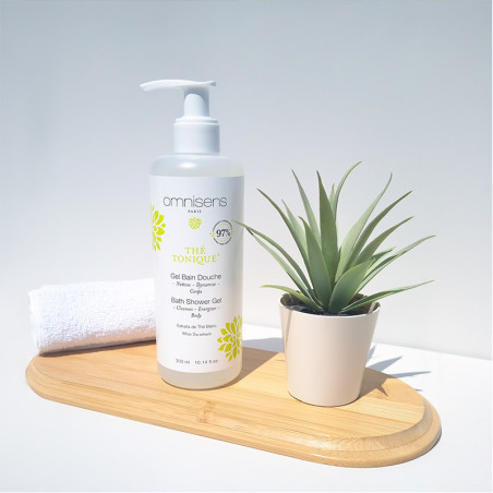 Photo of Thé Tonique Bath Shower Gel on a wooden tray with a towel and a green plant