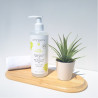 Photo of Thé Tonique Bath Shower Gel on a wooden tray with a towel and a green plant